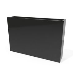 a large black box sitting on top of a white floor next to a planter