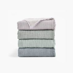 four folded towels stacked on top of each other