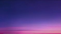 an airplane is flying in the sky at sunset or sunrise with pink and blue colors