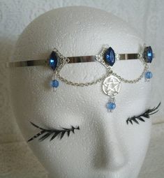 Pentacle Circlet This beautiful circlet has sterling silver plated filigree accents with blue faceted glass settings, blue glass bead drops, pewter silver pentacle and metal chain. Adjustable. Gothic Blue Metal Jewelry, Blue Gothic Metal Jewelry, Gothic Nickel-free Silver Body Jewelry, Nickel-free Gothic Silver Body Jewelry, Nickel-free Silver Gothic Body Jewelry, Adjustable Silver Spiritual Body Jewelry, Adjustable Silver Gothic Body Jewelry, Adjustable Gothic Jewelry For Festivals, Spiritual Silver Body Jewelry For Festivals