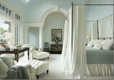 an image of a bedroom with white furniture and curtains on the bed, in front of a large window