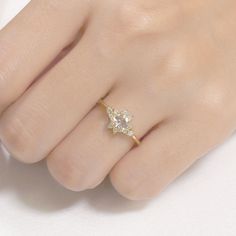 a woman's hand with a diamond ring on it