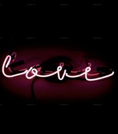 a neon sign with the word love in it's center on a black background