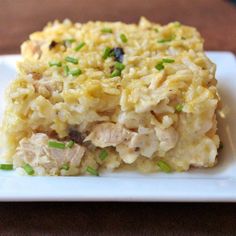 a white plate topped with rice and meat