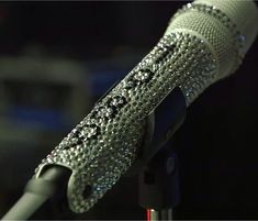 a close up of a microphone with diamonds on it