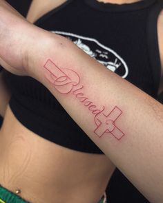 a woman's arm with the word hope written on it and a cross in red ink