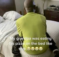 a man sitting on top of a bed in front of a tv screen with the caption, my grandpa was eating his pizza on the bed like that