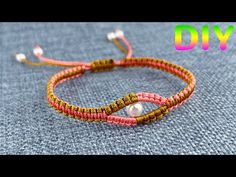 the diy bracelet is made with two different colors of thread and pearls on it