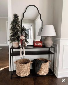 a shelf with baskets and a stuffed animal on it in front of a christmas tree