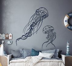 a living room with a couch and wall decals on the walls, including a large jellyfish