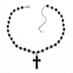 "Indulge in edgy elegance with our Silver Gothic Beaded Cross Charm Necklace. Made with stunning black beads and a beautifully intricate cross charm, this necklace is the perfect accessory for anyone looking to make a statement. Showcase your unique style and add a touch of sophistication to any outfit with this one-of-a-kind piece! Good to Know: Adjustable fastening  Silver Plated  Nickel Free  Charm Size 20mm x 10mm  Necklace Length 21\" - 24\" with Adjuster" Edgy Black Beaded Jewelry, Gothic Black Necklace With Black Beads, Gothic Black Cross Pendant Necklace, Black Gothic Jewelry With Beaded Chain, Gothic Black Cross Necklace Gift, Edgy Metal Cross Necklace, Gothic Black Beaded Necklace, Gothic Black Crucifix Cross Necklace, Black Beaded Crucifix Jewelry