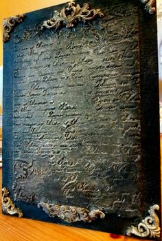 an old book sitting on top of a wooden table