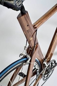 a close up of a bike with wood and blue stripes on the seatposts