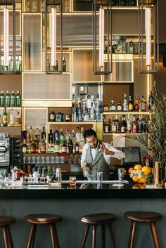 a man is behind the bar preparing drinks