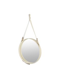 a round mirror hanging from the ceiling with a white cord around it's neck