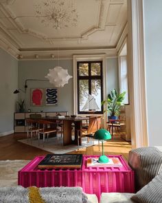 a living room filled with furniture and a large window in the middle of the room