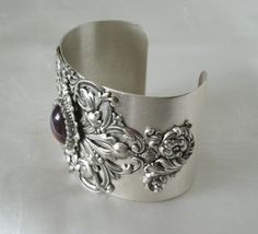 "This beautiful silver plated cuff bracelet has a silver plated floral design and a glass dragon's breath fire opal setting with rhinestone accents. 2\" wide. Adjustable." Ornate Adjustable Cuff Bracelet For Formal Occasions, Nickel-free Silver Cuff Bracelet For Wedding, Silver Nickel-free Cuff Bracelet For Wedding, Victorian Adjustable Bangle Cuff Bracelet, Victorian Sterling Silver Bracelet For Wedding, Handmade Victorian Cuff Bracelet For Wedding, Elegant Antique Silver Cuff Bracelet, Victorian Sterling Silver Wedding Bracelet, Elegant Antique Silver Bangle