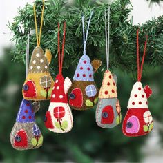 christmas ornaments hanging from a tree in the shape of small houses with polka dots on them