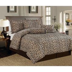 a leopard print comforter set on a bed