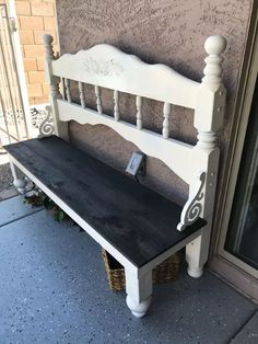 a white bench sitting on the side of a building next to a door with a cell phone in it