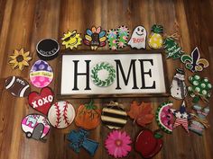 a sign that says home surrounded by lots of different types of buttons and magnets