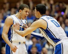 two basketball players are talking to each other