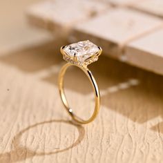 a diamond ring sitting on top of a table