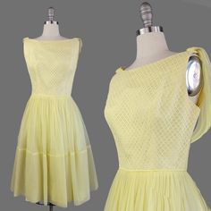 ~1950s sleeveless pastel yellow party dress with chiffon skirt and shoulder sash  ~ Sash can hang loosely or drape in a soft tie in the back ~Bodice comprised of pastel yellow lace layered over yellow cotton faille to give it body, plus taffeta around the interior of the neckline  ~Waist trimmed with cording  ~Skirt gathered at waistline and is comprised of chiffon laid over taffeta over a built-in crinoline slip ~Super deep hem gives this dress even more presence ~Hidden metal back zipper Size Yellow 1950s Style Dress For Garden Party, 1950s Style Vintage Yellow Dress For Spring, 1950s Style Yellow Party Dress, Yellow 1950s Dress, Yellow 1950s Style Sleeveless Dress, Yellow Party Dresses, Yellow Sleeveless 1950s Dress, Yellow 1950s Sleeveless Dress, 1950s Cocktail Dress