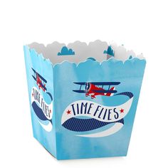 a blue paper bag with an airplane and plane design on the front that says time flies