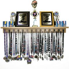 an assortment of trophies and medals on a shelf