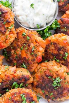 crab cakes with sour cream and parsley on the side