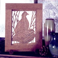 a wooden frame sitting on top of a shelf next to vases and other items