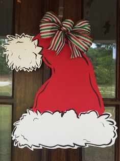 a door hanger with a santa clause hat on it