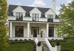 a white house with black shutters on the front