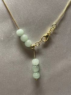 Natural Jade Bead Necklace . Simple design and nice looking. Material : Jade , Gold filled chain Jade Size: 6mmColor: Light Green Jade , Yellow gold filled & Silver color chain Chain Length: adjustable from 14 inches up to 16.5 inches. Packing : Nice silk Bag Dainty Gold Jade Necklace, Gold Jade Necklaces With Round Beads, Adjustable Beaded Necklaces With Round Beads And Chain, Adjustable Beaded Necklace With Round Beads And Chain, Gold Beaded Jade Necklace, Gold Jade Beaded Necklaces With Round Beads, Gold Jade Round Beaded Necklaces, Gold Beaded Necklace With Adjustable Chain, Green Jewelry With Round Beads And Adjustable Chain