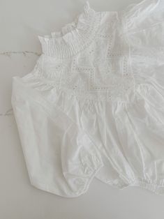 Indulge your little one in refined luxury with our Embroidered Cotton Romper. Made from soft cotton and featuring intricate embroidered details, this romper exudes sophistication. The high neck and long puffy sleeves add an extra touch of elegance to this adorable baby romper. A must-have for any stylish little one. This item requires a 10-12 day processing before being shipped. Spring Long Sleeve Tops For Baptism, White Long Sleeve Tops For Baptism, Spring Baptism Long Sleeve Tops, White Cotton Bubble Romper With Smocked Back, White Cotton Bubble Romper, Playful White Cotton Bubble Romper, White Smocked Cotton Bubble Romper, White Cotton Bubble Romper With Lace Trim, Long Puffy Sleeves