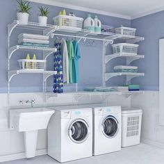 a washer and dryer in a room with shelving on the wall behind them