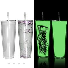 three different colored cups with straws in them and one has a drawing on the side