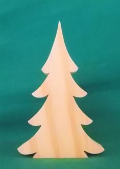 a white wooden christmas tree on a green background