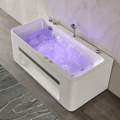 a white bath tub sitting on top of a tiled floor