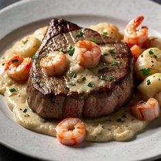 a steak with shrimp and grits on a plate