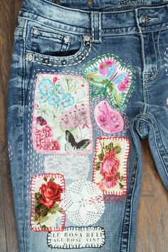 a pair of jeans with patches and flowers on them