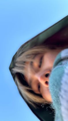 a blurry image of a woman's face and neck with her hair in the wind