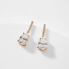 ABOUT THE PRODUCTA dainty pear shaped cubic zirconia drop accented by glimmering pave CZ are sure to light up your lobes. Metal: Brass Plating: 18KT Gold or RhodiumStones: Cubic ZirconiaLength: 0.875 inWidth: 0.25 in Cubic Zirconia Teardrop Earrings With Sparkling Stones, Classic Teardrop Earrings With Sparkling Stones, Teardrop Pendant Earrings With Sparkling Stones, Classic Teardrop Earrings With Cubic Zirconia Pendant, Classic Teardrop Cubic Zirconia Earrings, Classic Teardrop Earrings With Cubic Zirconia, Classic Cubic Zirconia Teardrop Earrings, Pear-shaped Cubic Zirconia Teardrop Earrings For Party, Sparkling Cubic Zirconia Teardrop Earrings