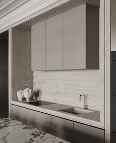 a modern kitchen with marble counter tops and white cupboards on either side of the sink