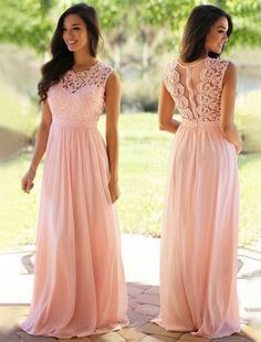 two women in long pink dresses standing on a brick walkway, one wearing a lace top and