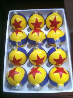 twelve yellow and red christmas ornaments in a box