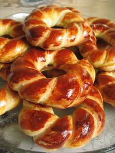 there are many croissants on the glass plate