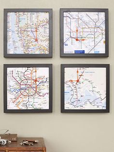 four framed maps hang on the wall above a dresser