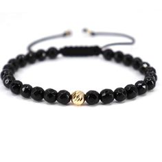 ✨Discover the pinnacle of masculine elegance with our exclusive handcrafted bracelet, featuring bold 6mm faceted black onyx beads, centered with a striking 6mm 14K gold bead and complemented by two 2.5mm 14K gold beads at the adjustable closure. This piece is a testament to timeless style and sophistication. Gold Bracelet Key Features: ✅Superior Craftsmanship: Each bracelet is carefully handcrafted, showcasing the meticulous attention to detail and dedication to quality. ✅Luxurious Materials: Ad Modern Black Hand-strung Bracelets, Modern Black Hand-strung Bracelet, Luxury Black Adjustable Beaded Bracelet, Elegant Hand-strung Bracelets, Luxury Adjustable Black Wristband, Modern Black Bracelets With Gemstone Beads, Luxury Black Hand-strung Beaded Bracelets, Luxury Black Bracelets With 8mm Beads, Luxury Black Onyx Beaded Bracelets